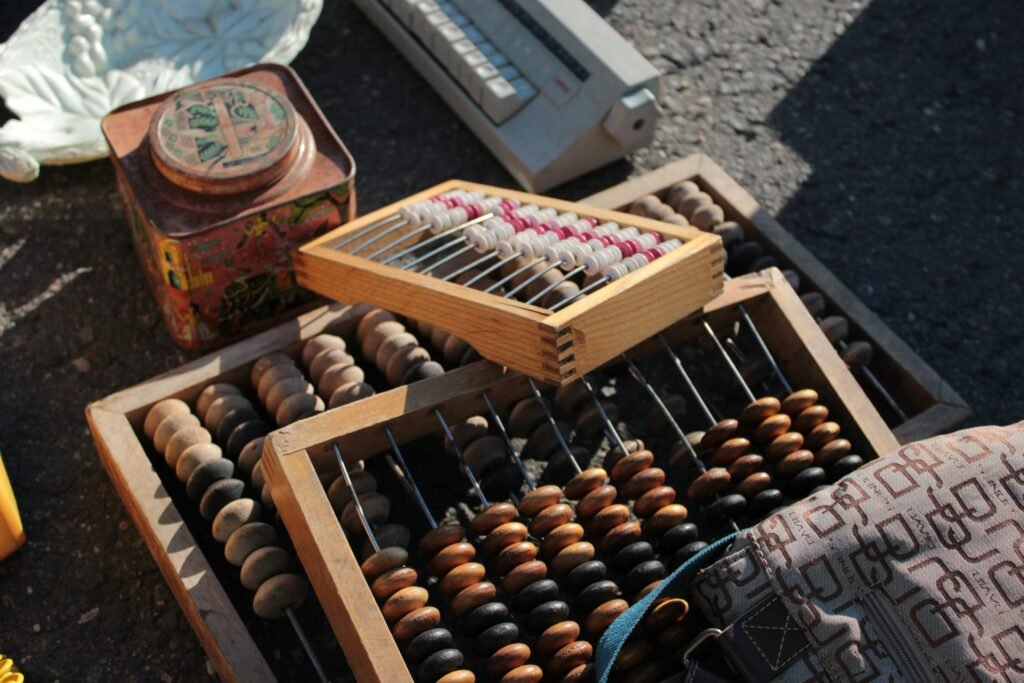 Collection of vintage abacuses and retro items on a sunlit surface.